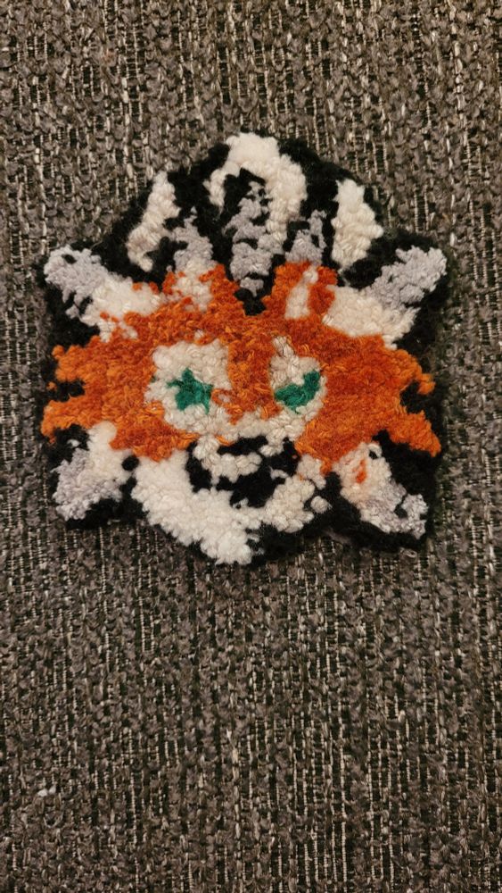 A needle punch mug rug of a Dusk Form Lycanroc