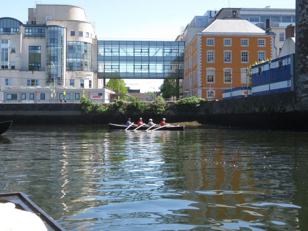 Currach row past Mercy Hospital & Tyndall on river lee