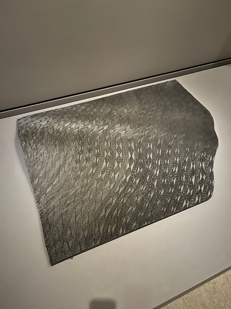 Intricate repeating patterns etched into a discarded piece of rubber conveyor belt