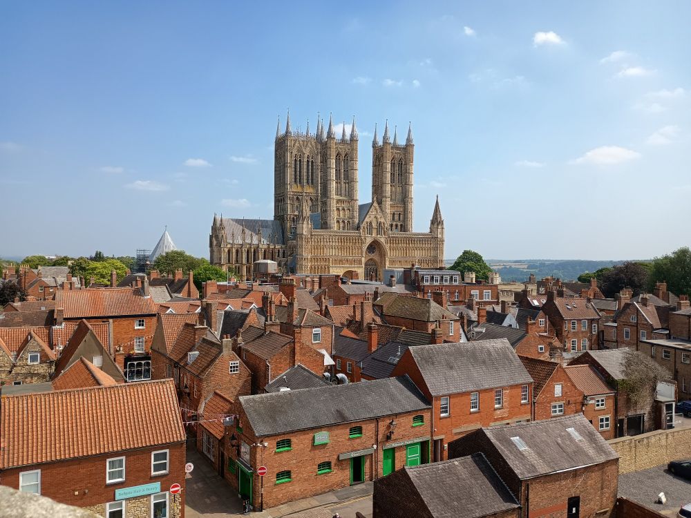 The west frontof Lincoln Cathedral rising above the tangle of roofs of the town 