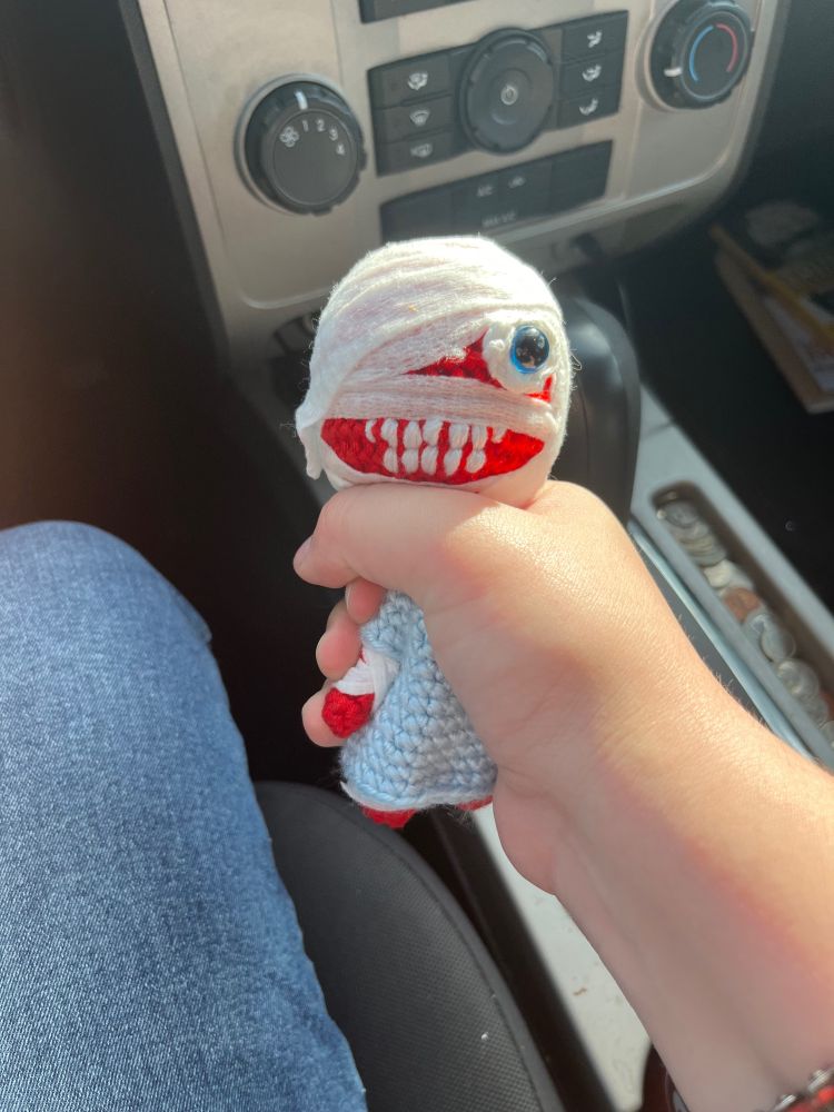 Captain curly from the game mouth washing held in a choke hold hand, He’s wearing a medical gown and bandages