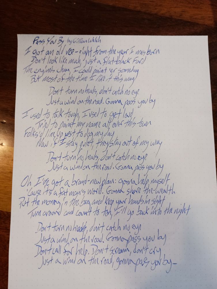 The lyrics to Pass You By by Gillian Welsh scrawled in blue ink