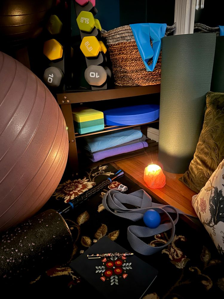 Corner of a dark office piled with stretching and yoga equipment 