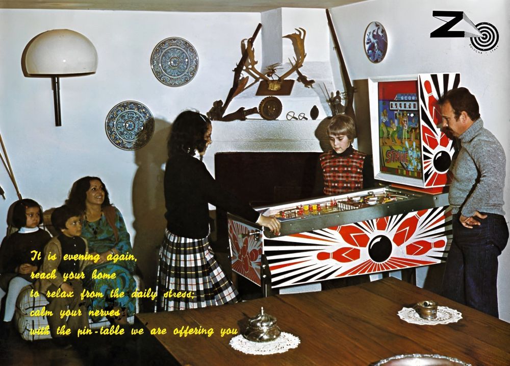 A clearly staged, brutally lit living room dominated by a full sized pinball machine, with center-frame guns and hunting trophies. The text reads: "It is evening again, reach your home to relax from the daily stress; calm your nerves, with the pin-table we are offering you"