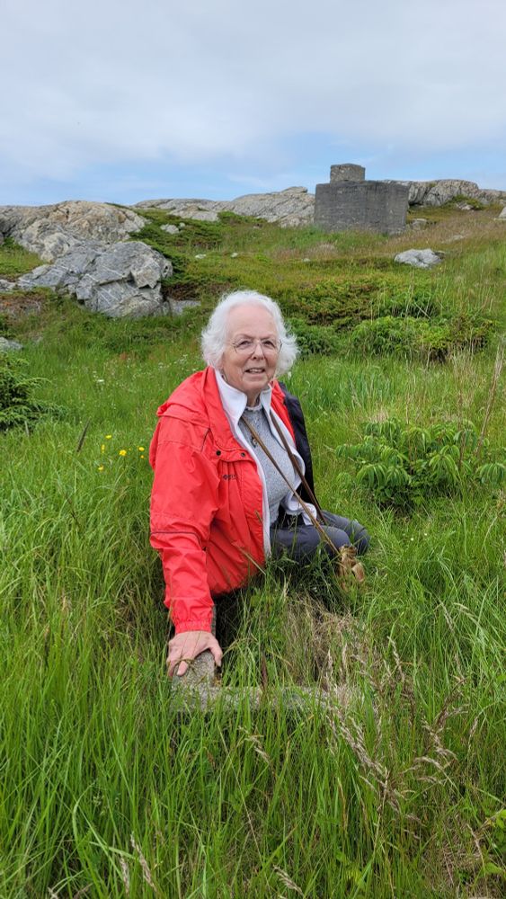 My 80 year old mother sitting where her mother's childhood home used to stand.