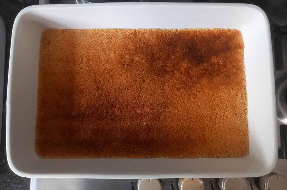 Cheesecake crust baked and set, ready to receive the cheesy and creamy batter