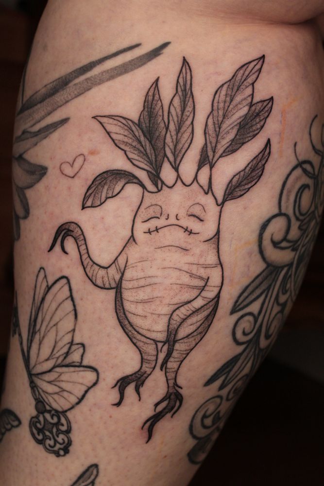 Mandrake tattoo with a little heart next to it
