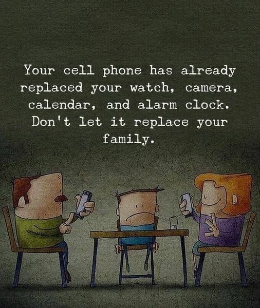 Family at dinner table with cell phones on their hands