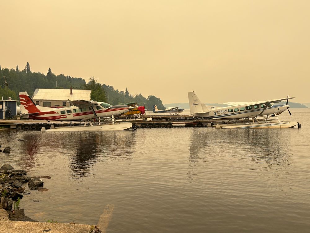 Float planes with a smoky background due to forest fires 