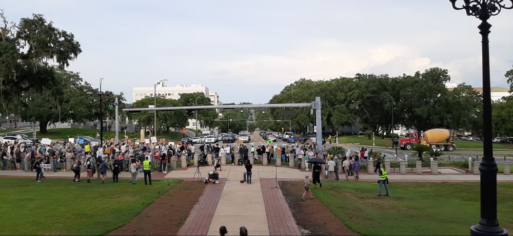 A large group of people gathered benestill She's justifiably so right now a traffic like what signs protesting ice detaining over 100 local hispanic workers