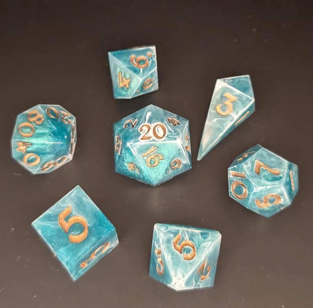 A glittery green dice set for DnD and similar TTRPG systems, designed with white swirls and dark golden numbers, inspired by treasures lost at sea