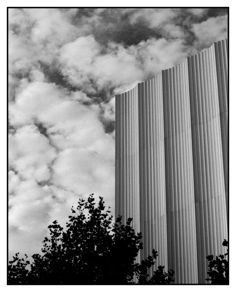 Tree in the bottom nearly dark as the clouds and the building were so bright and that's what the camera meter suggested to use
