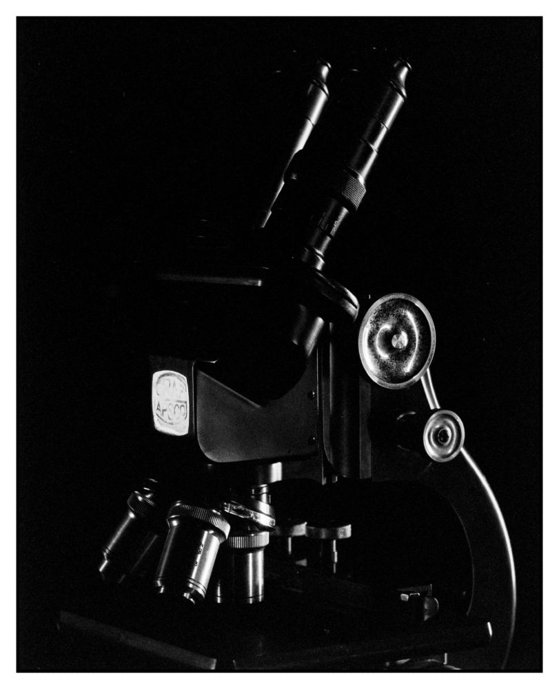 Closer and f16 and 1/2 of a second

an old microscope in a studio shot lit from the size against a black background