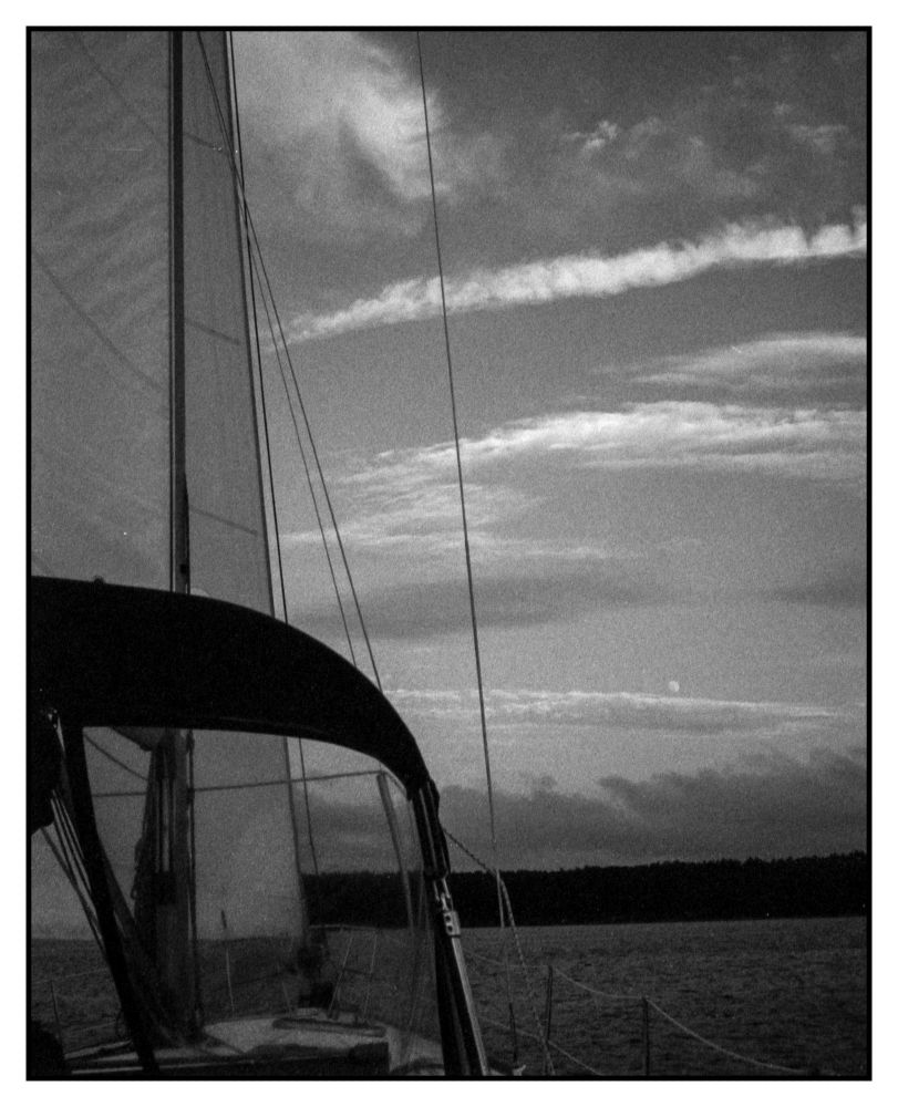 Finally a shot from the cockpit with the dodger up and stipes of clouds and the moon. I'd taken a chance the moon would show up on film. and it did.