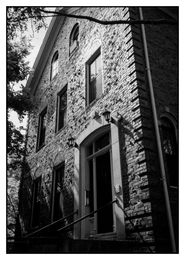 A there story brick building made with clinker Bricks casting subtle shadows in the late afternoon light. 