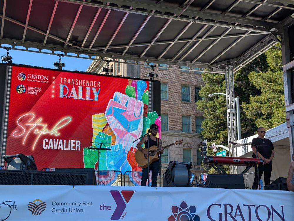 A photo of Steph Cavalier on stage performing music.