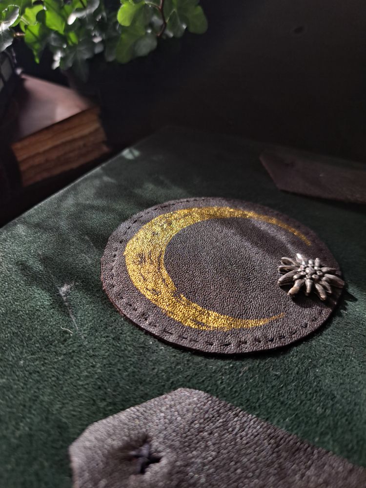 A closer look at the details on the cover. The golden sicle moon shines when light hits it.