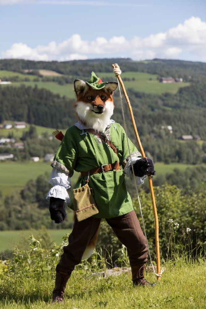 Fox fursuiter posing with bow and arrow