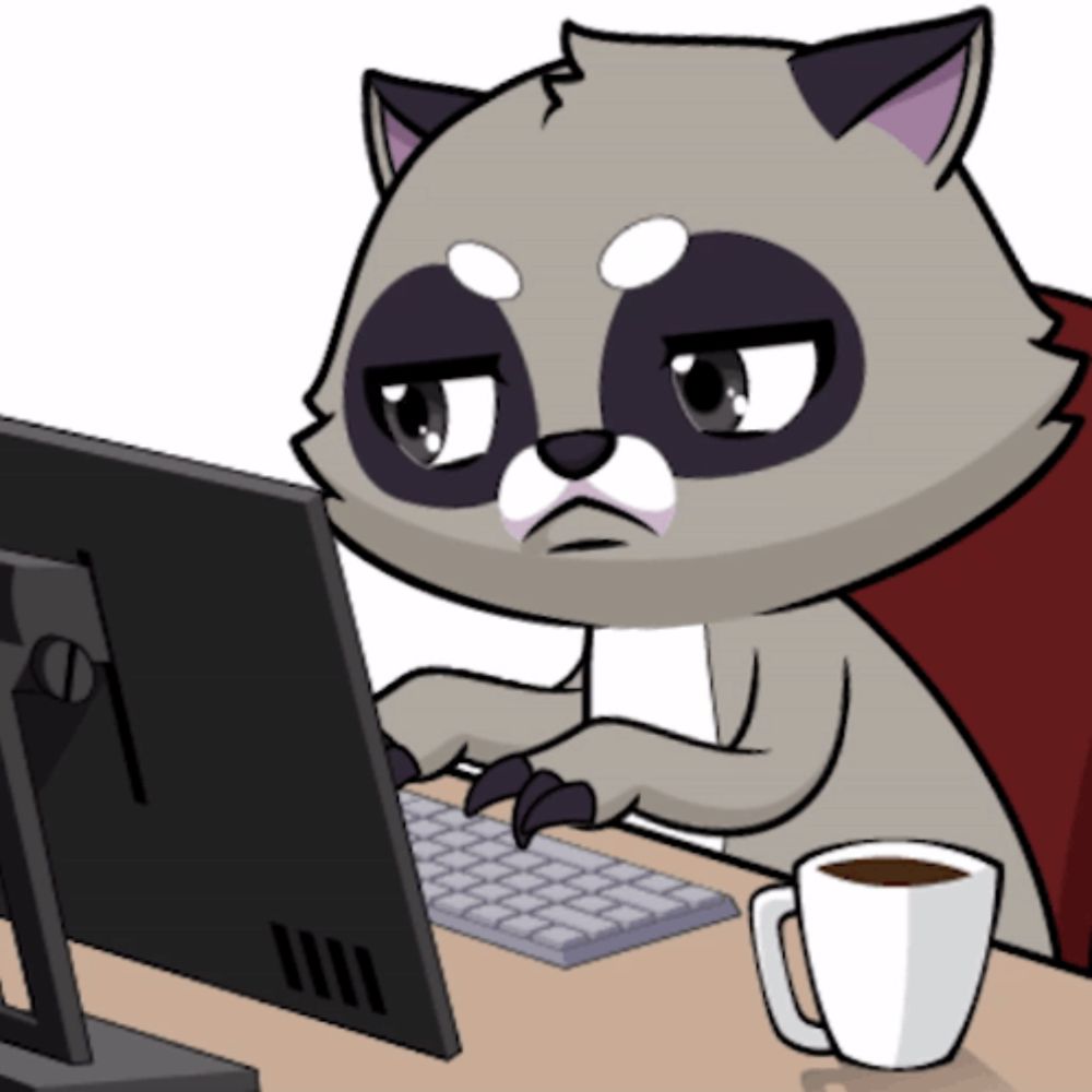 a cartoon raccoon sits at a desk typing on a computer keyboard