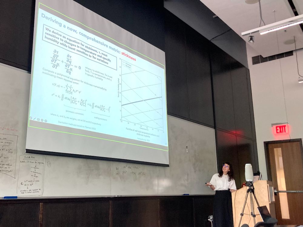 Casey points to the results of her dissertation chapter on a presentation slide during her defense.