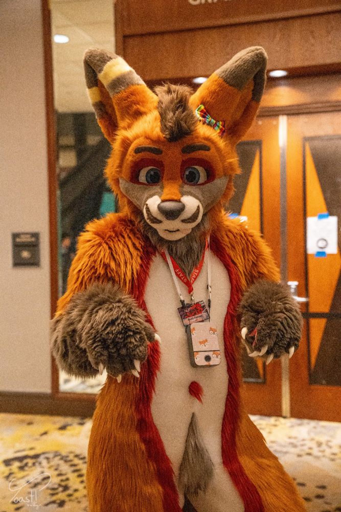 Sven poses playfully in a convention hallway at Furpocalypse 2024