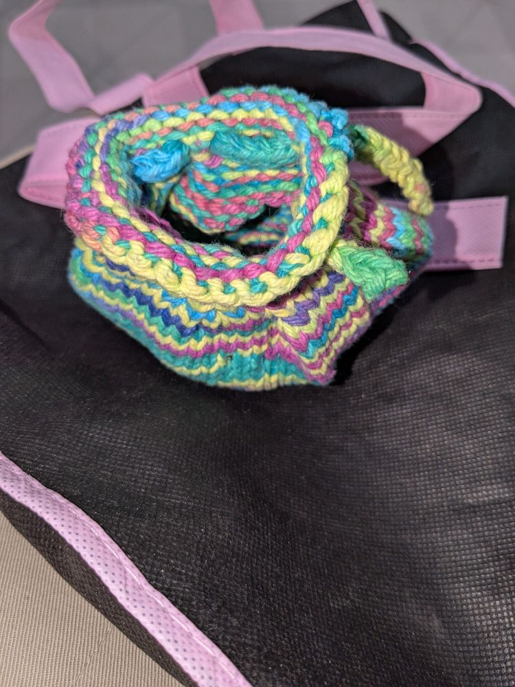 Small knit rainbow money bag, open. Looking inside