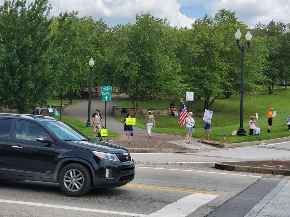 Protesters opposed to Donald Trump hold signs on four corners of a busy intersection in Fairmont, WV.