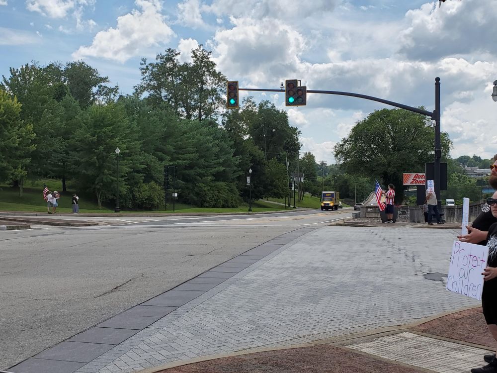 Protesters opposed to Donald Trump hold signs on four corners of a busy intersection in Fairmont, WV.