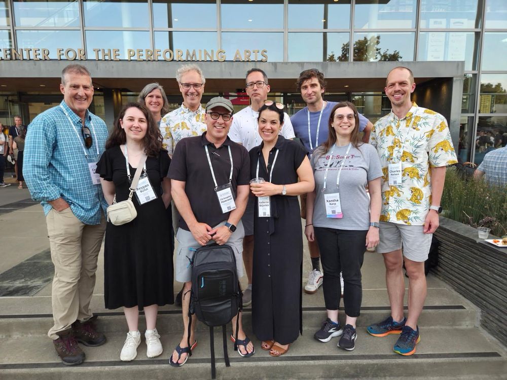 Ten people standing in front of the Mondavi Center, smiling for the camera. Victor Ambros plus current and former lab members. 