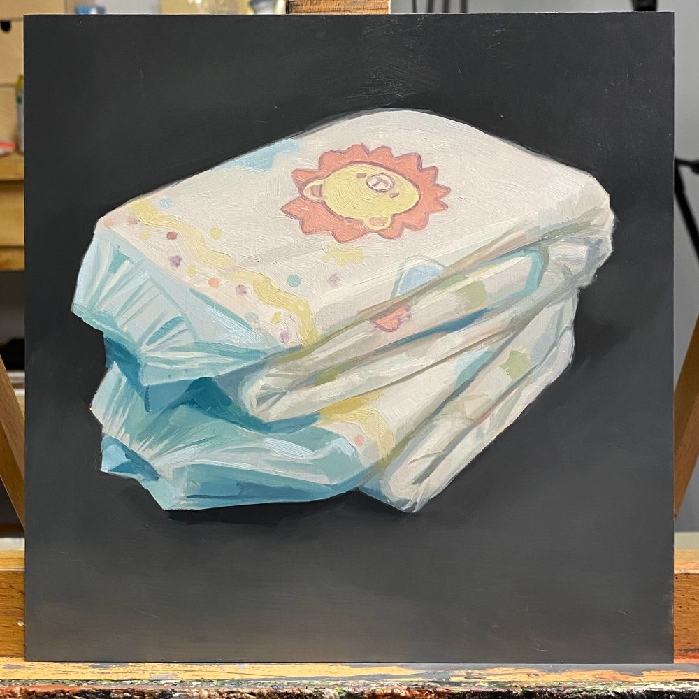 oil painting of two folded "Little King" ABU diapers stacked ontop of one another upon a dark gray background.