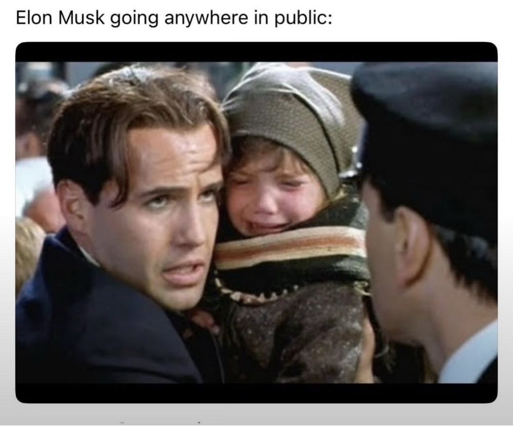 A screen capture from the movie Titanic depicting Billy Zane’s character holding a child to bluff his way onto a lifeboat. The reference to Musk and his child is *chef’s kiss*
