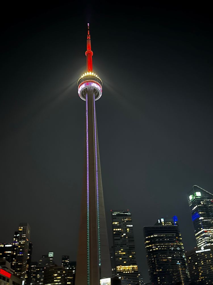 The CN tower in Toronto.  Lit up white and red 