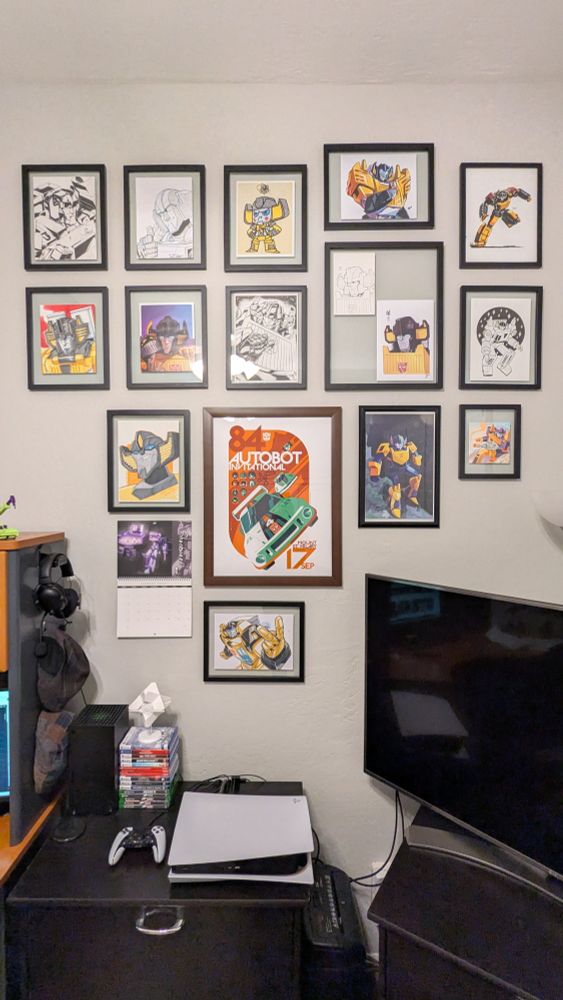 My wall of different Transformers Sunstreaker commissions. If I had more wall space, I'd rearrange them a bit differently to highlight some of the newer pieces.