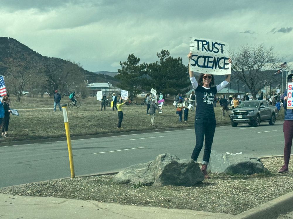 Protester holding sign "Trust Science"