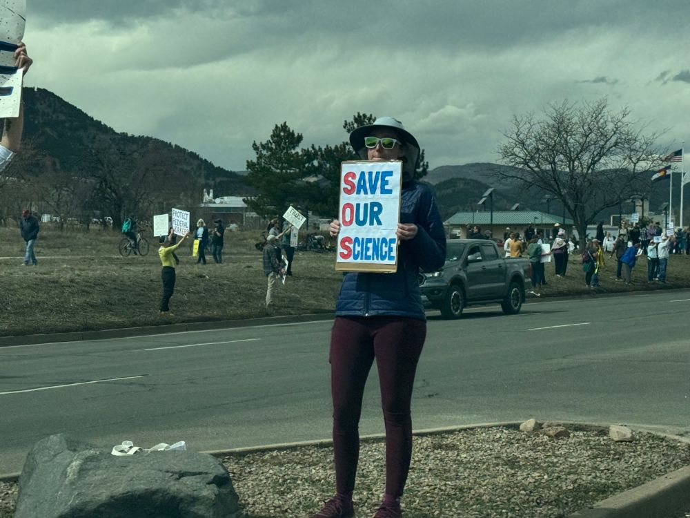 Protester holding sign "Save Our Science"