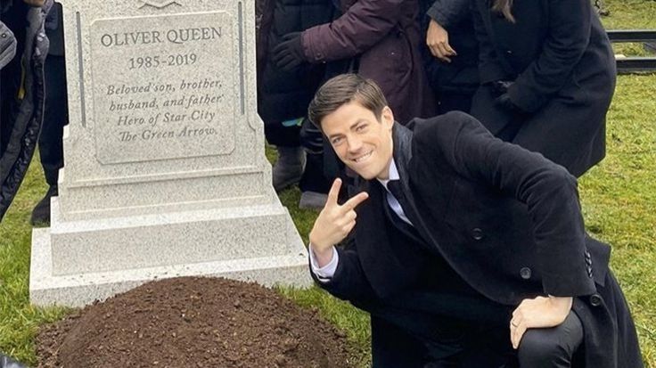 The meme of the man kneeling in front of a fresh grave, giving the peace sign