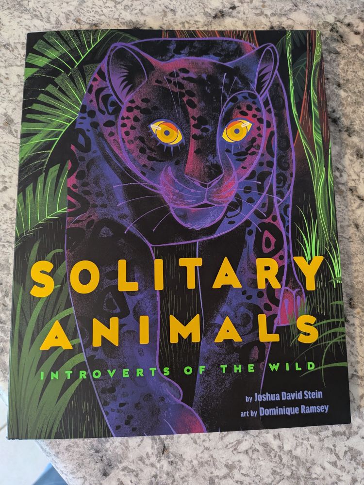 Photograph of the children's book Solitary Animals by Joshua David Stein and illustrated by Dominique Ramsey, featuring a leopard win purple tones and brilliant yellow/gold eyes, with plants adorning the black background 