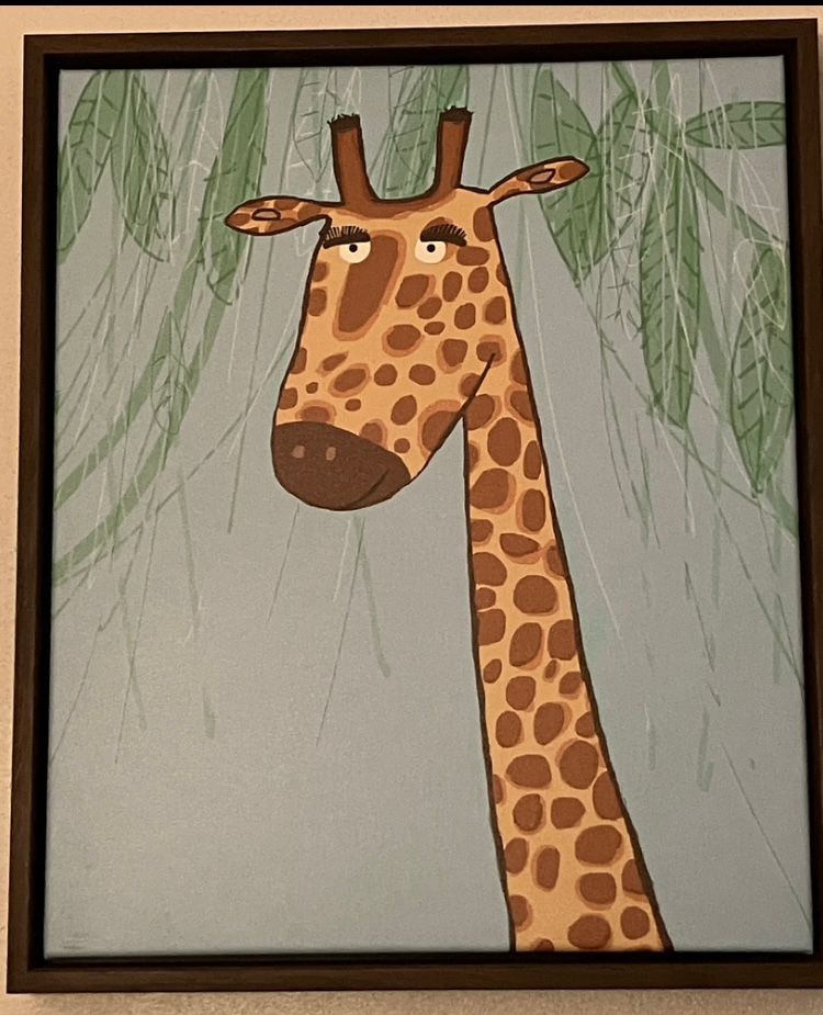 Giraffe art from Goodwill. The giraffe has long eyelashes. 
