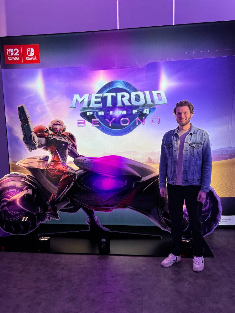 Me standing next to a Samus standee on the Prime 4 motorcycle