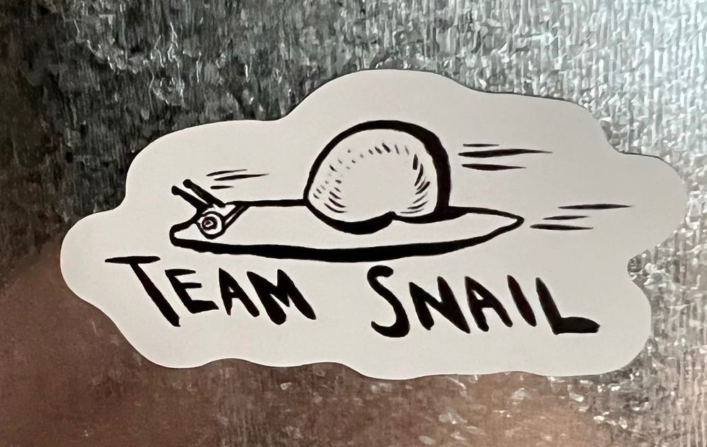 Magnet with a snail racing in goggles and Team Snail written underneath