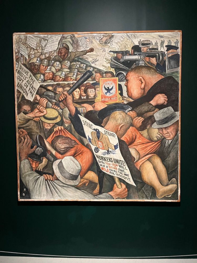 A panel from Diego Rivera’s “Portrrait of America” entitled “A New Deal”, from 1933-34. It shows a violent strike scene.