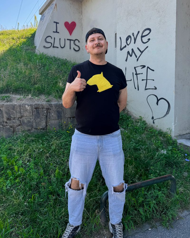 bull standing in front of graffiti reading I ❤️ SLUTS and I LOVE MY LIFE, in Zagreb, Croatia