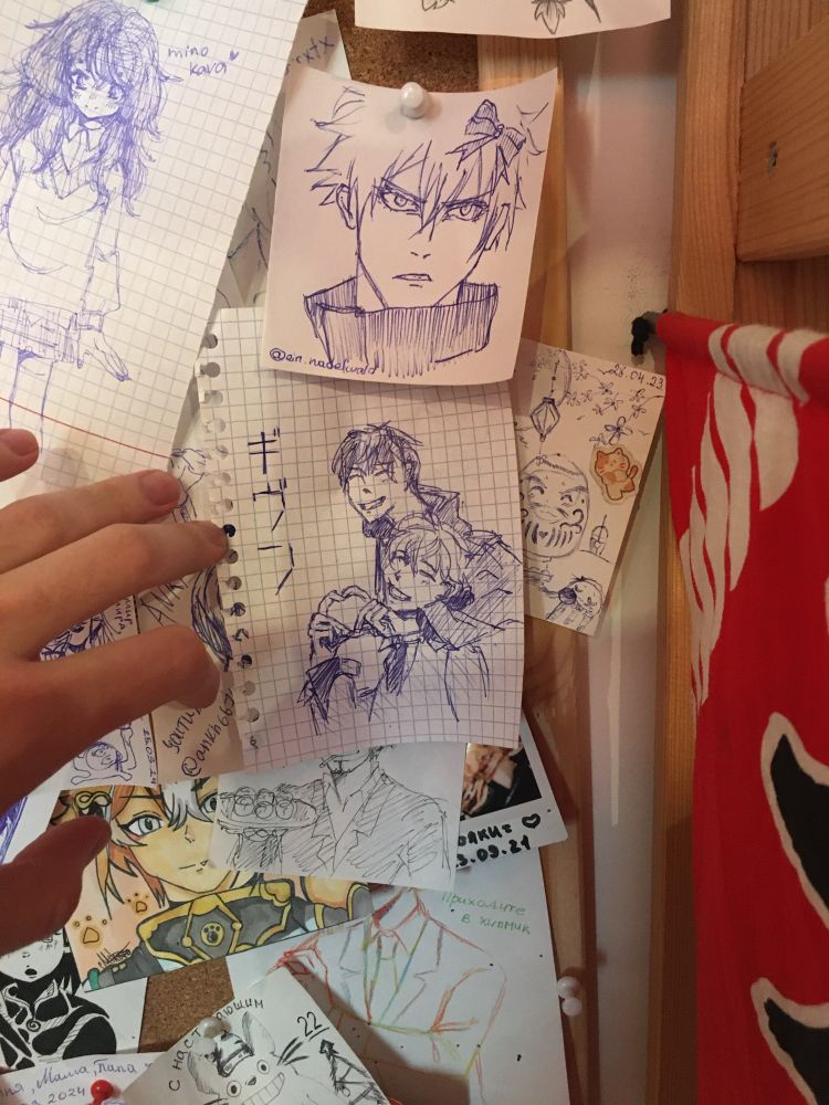 A rough ballpoint pen sketch of two guys hugging and making a finger heart on a wall of fanarts in an Asian cafe