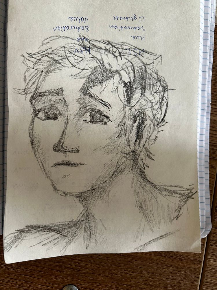 A rough black graphite sketch of a young face