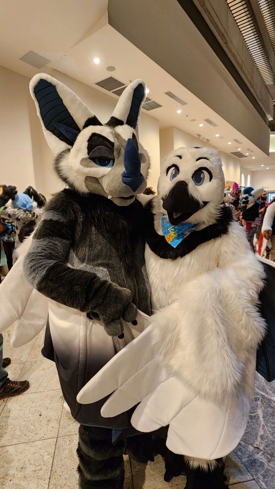 bat friend and bird friend, struggling to pose for a pic with 2 sets of ridiculous wings at FWA2025!