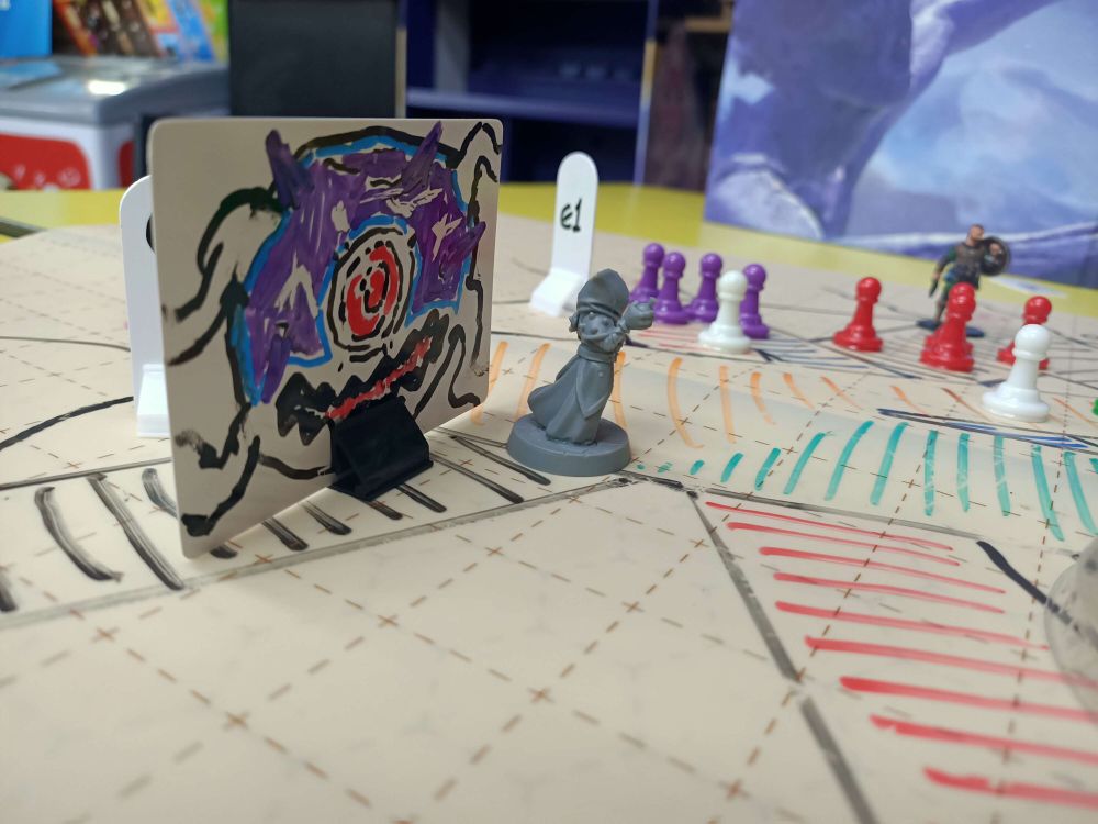 Photo of a D&D battle map showing a Beholder looming behind a player character.