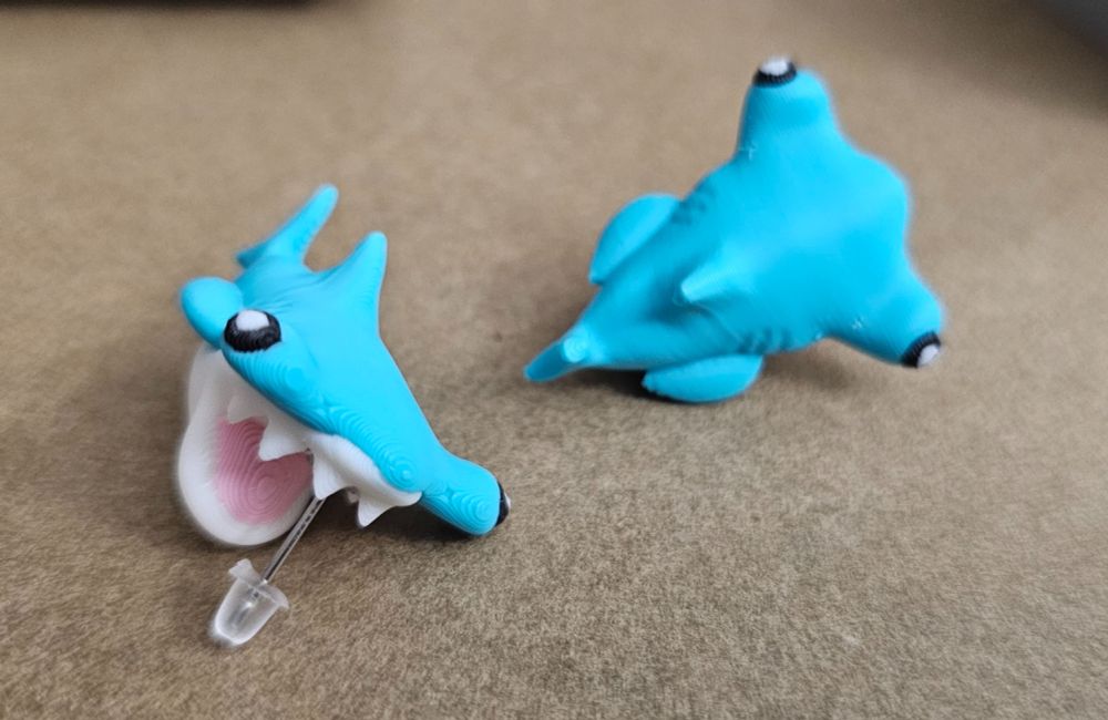Hammerhead sharks! They are a lovely turquoise, and have the distinctive cephalofoil and some fun chompy teeth. 