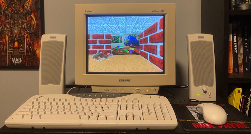 3D Maze screensaver on a Sony Trinitron monitor. There is a rat and a backdrop with a globe and Lego bricks