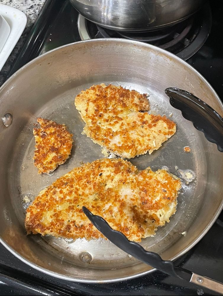 photo of chicken parmesan in on with beautiful golden crust formed