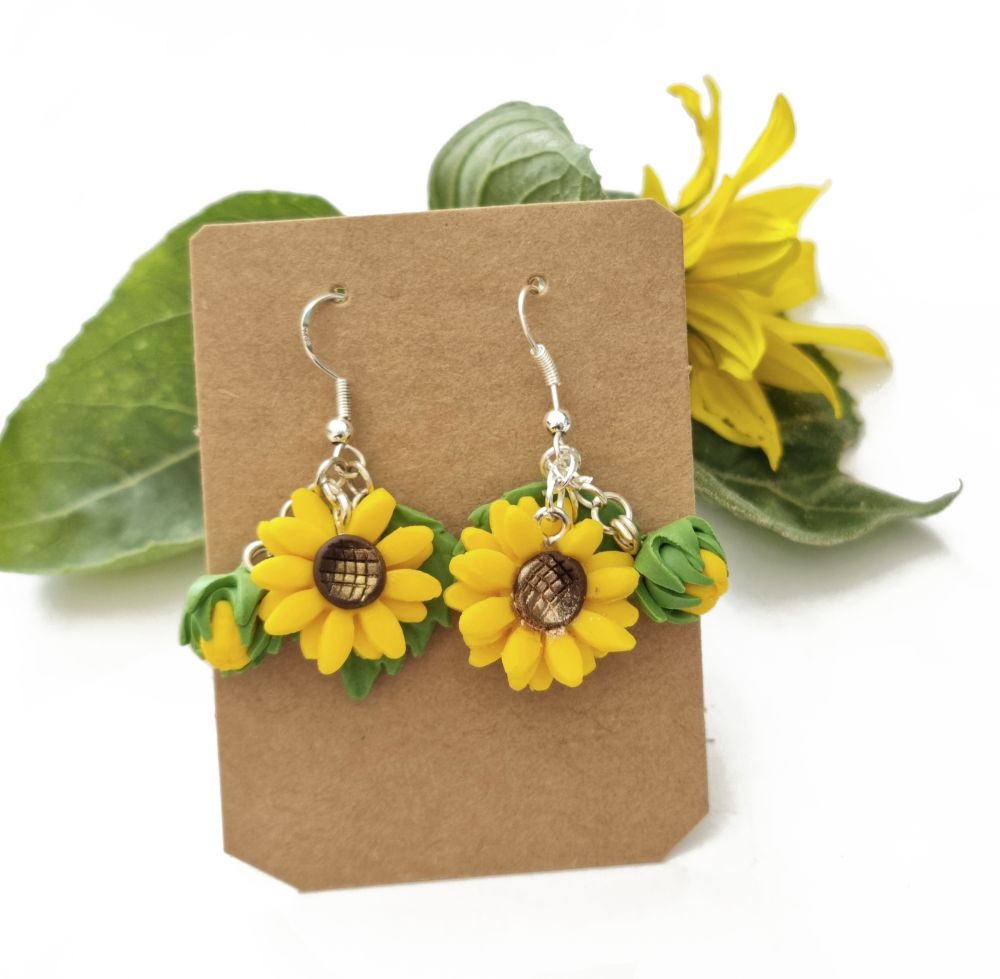 Handmade polymer clay Sunflower earrings on a display card